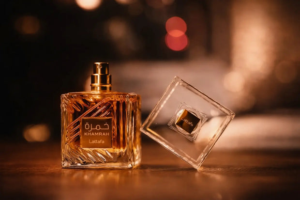 Two perfume bottles on a wooden surface with a blurred background